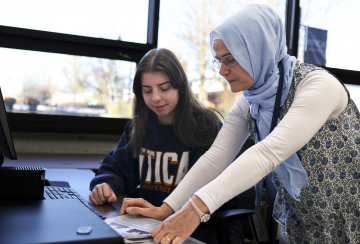 Physics Professor Hava Turkakin works with a student at the computer.